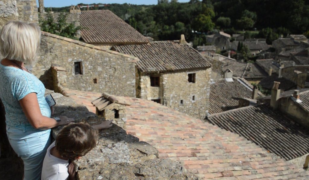 Famille sur une terrasse en pierre surplombant un village ardéchois près du Mas Saint Antoine